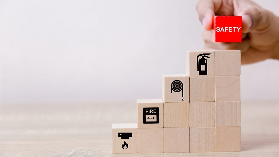 Place the wooden blocks into steps. 100 percent work safety concept.